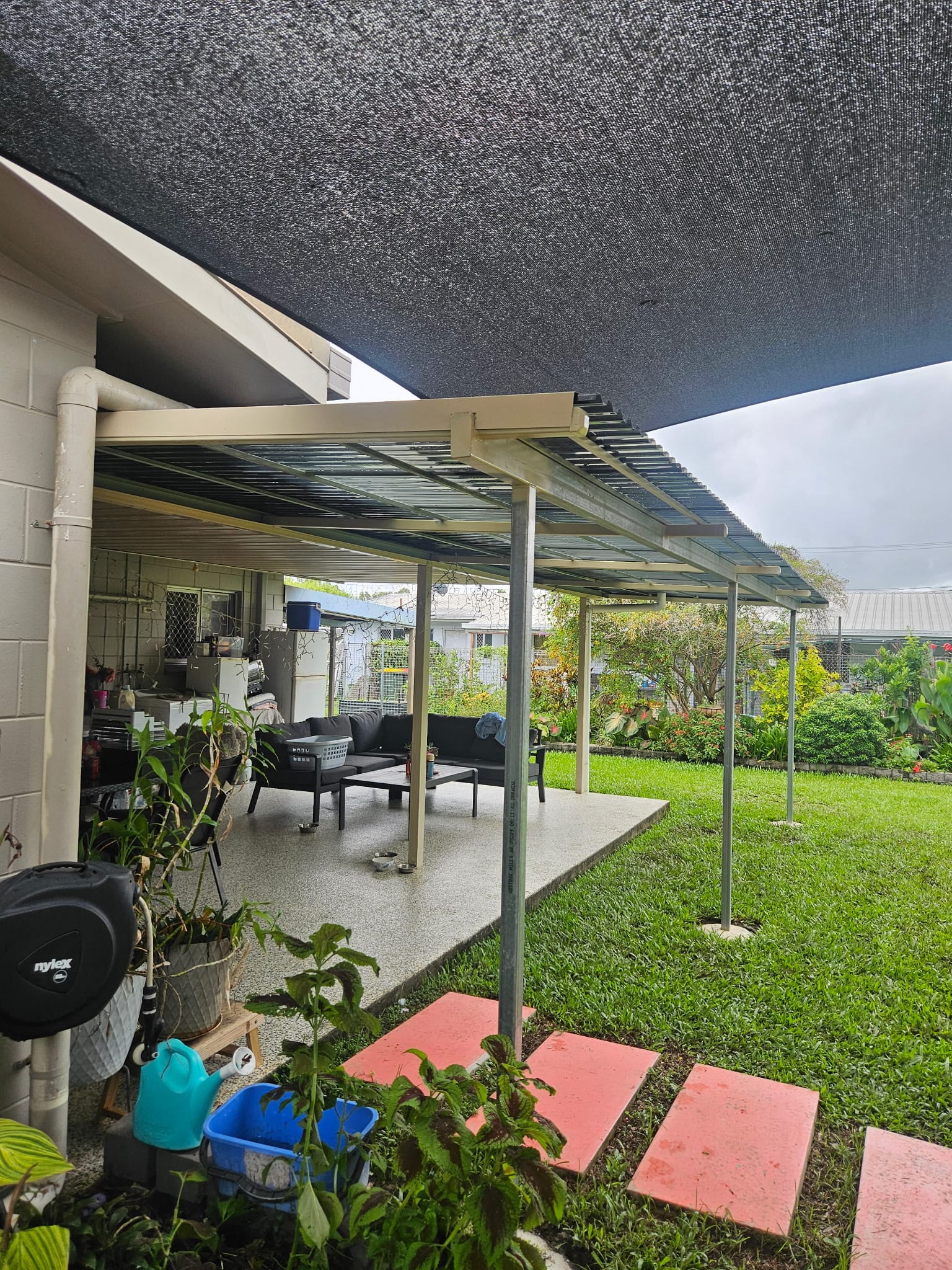 Extended patio and lawn-side cover installation